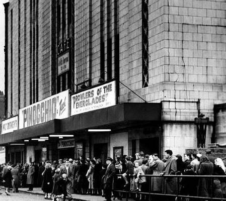 Queue's forming for what is believed to be the 1953 screening of Pinocchio due to the screening of 'Prowlers of The Everglades' advertised on the canopy boards